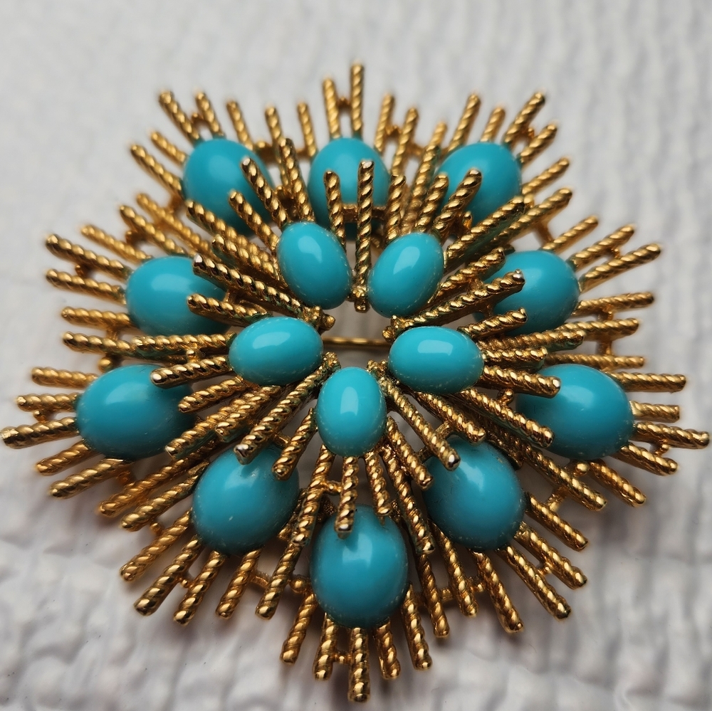 Vintage Avon gold tone and faux cabochon turquoise stones starburst brooch.